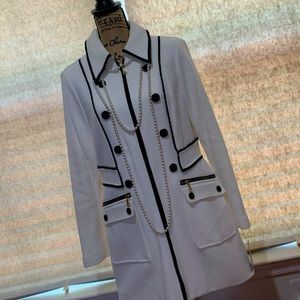 White dressy coat with black corking and buttons.